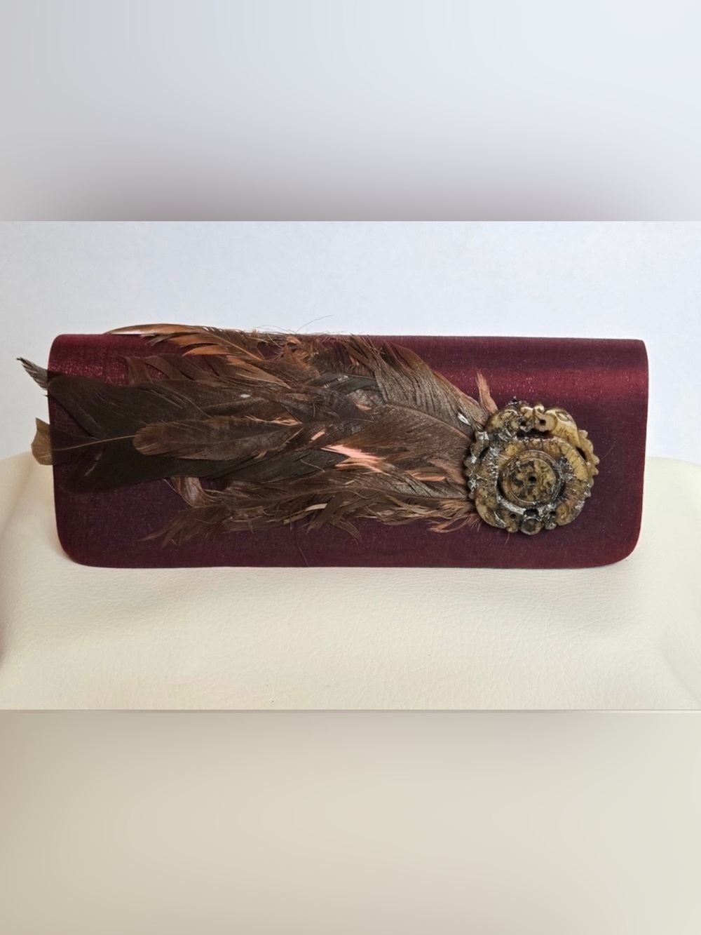 Feather embellished burgundy satin evening clutch